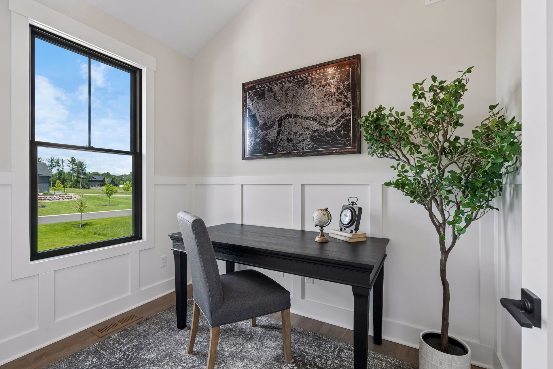 Private home office with wainscoting and large picture window